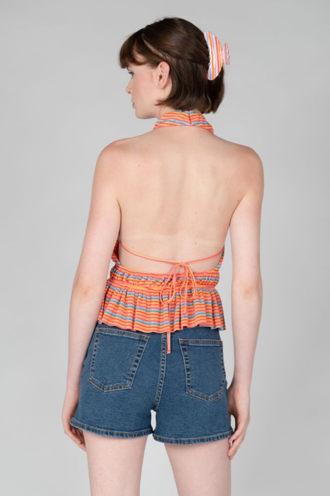 Back view of colorful knit halter tank with vibrant stripes, gathered waist, and feminine silhouette.