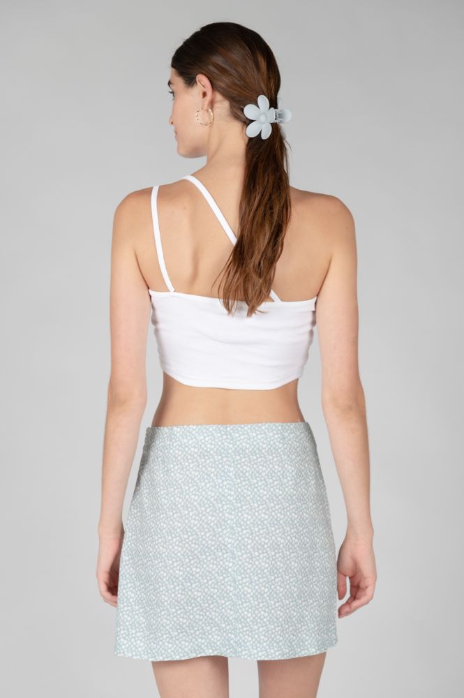 White cropped camisole top featuring layered shoulder straps and a minimalist silhouette.