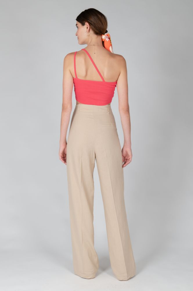 Back view of fitted asymmetrical pink crop top with double strap detail and modern feminine appeal.