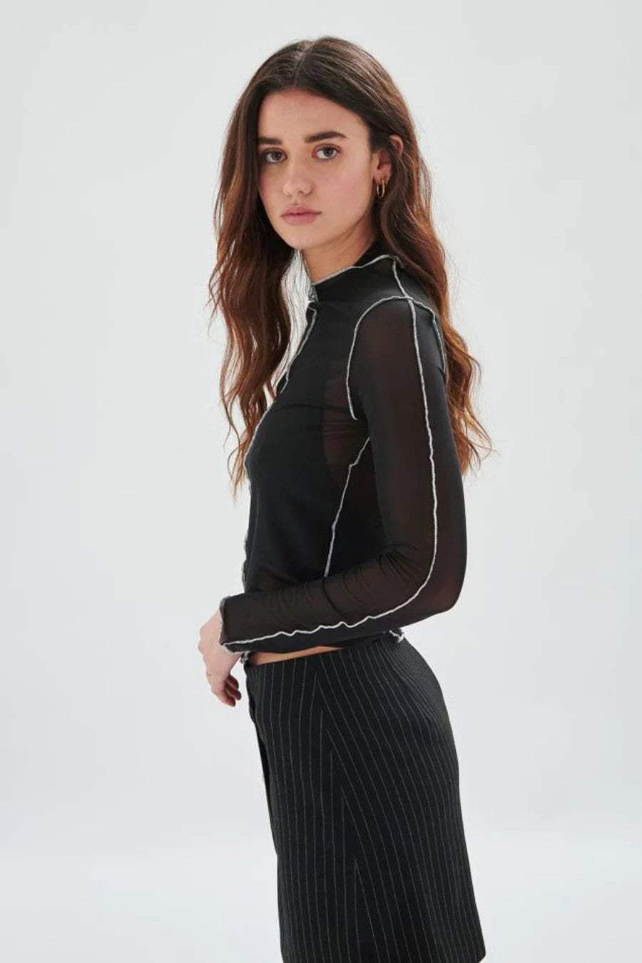 Best selling statement women’s mesh top in sheer black with contrast overlock seams and fitted long sleeves for stylish layering outfits.