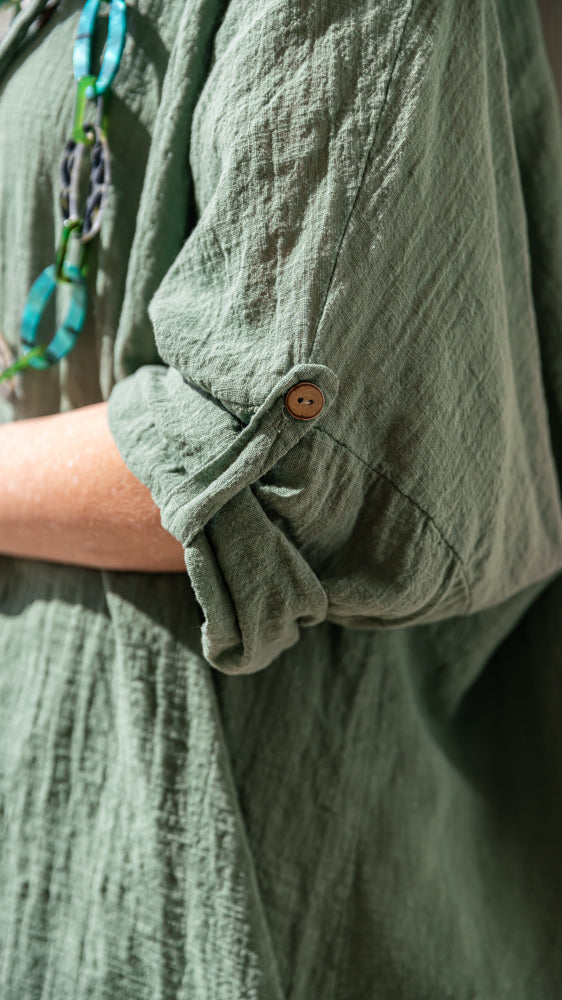 Close up of oversized shirt / blouse of fashion-forward monochrome green lounge outfit with relaxed tailoring and effortless comfort appeal.