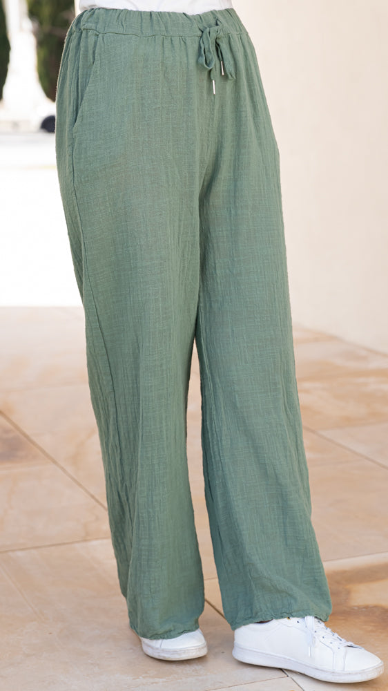 Elegant textured drawstring wide leg pants with breezy movement and effortless Mediterranean resort style.