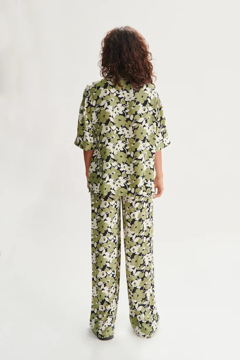 Back view of bohemian wide leg pants with abstract floral print and relaxed silhouette for vacation and resort wear looks.