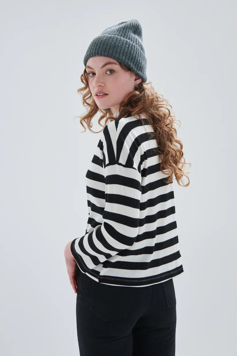 Women’s soft striped pullover featuring mock neck detail and relaxed long sleeves for cozy minimalist styling.