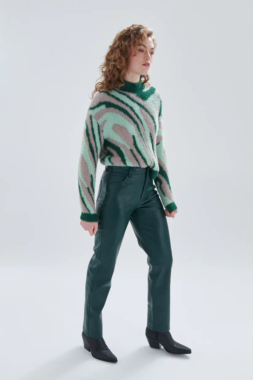Women’s dark emerald coated pants featuring slim fit tailoring and edgy minimalist fashion appeal for everyday wear.