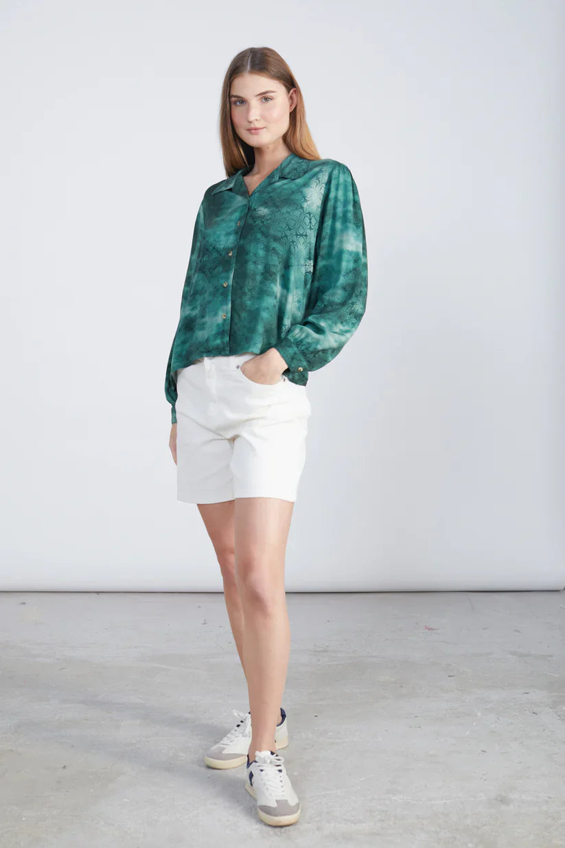 Boutique-style satin shirt with tonal floral motif and modern feminine streetwear sophistication.
