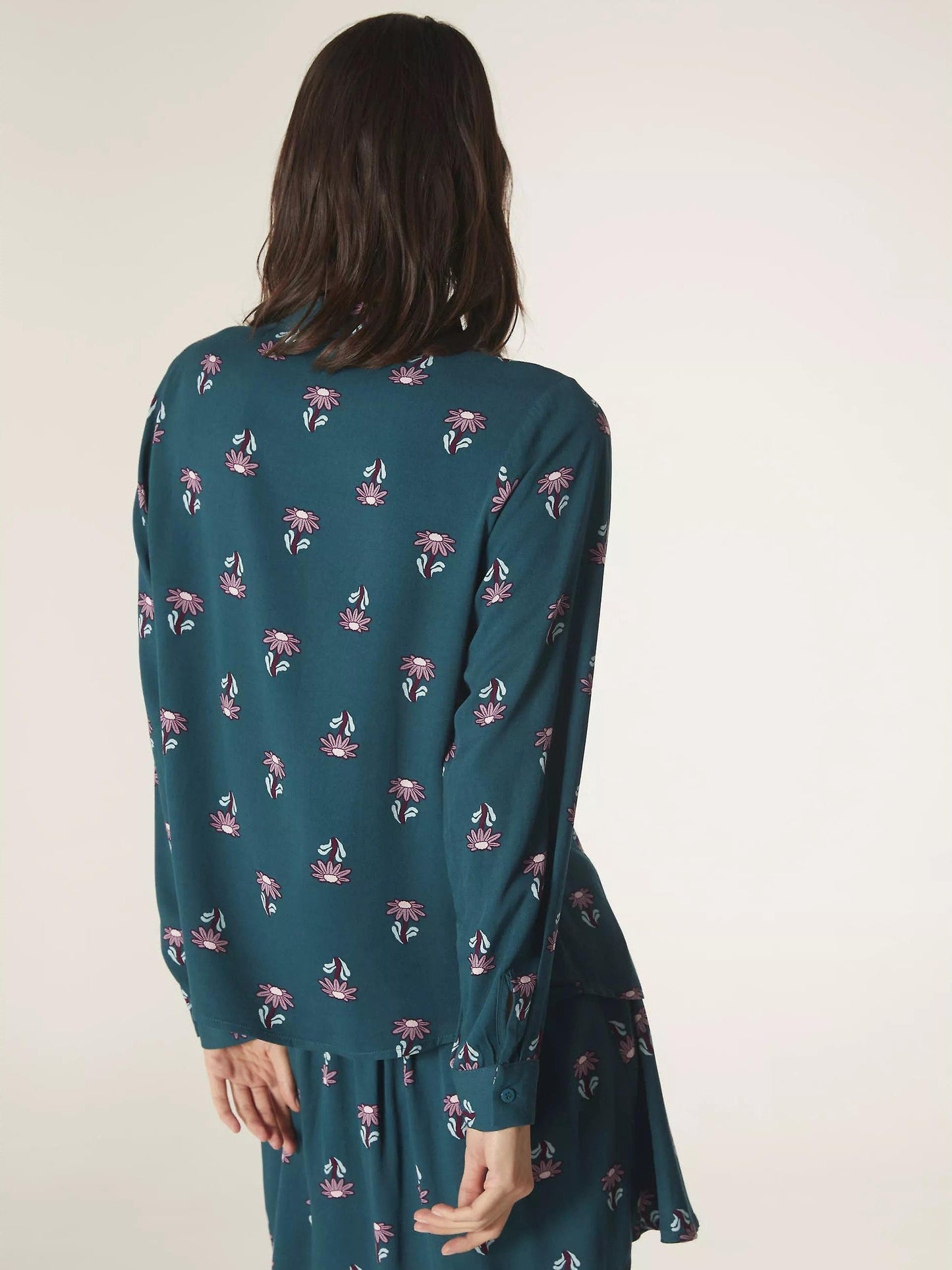 Contemporary women’s floral print blouse in rich teal tones with button-front closure for chic everyday outfit ideas.