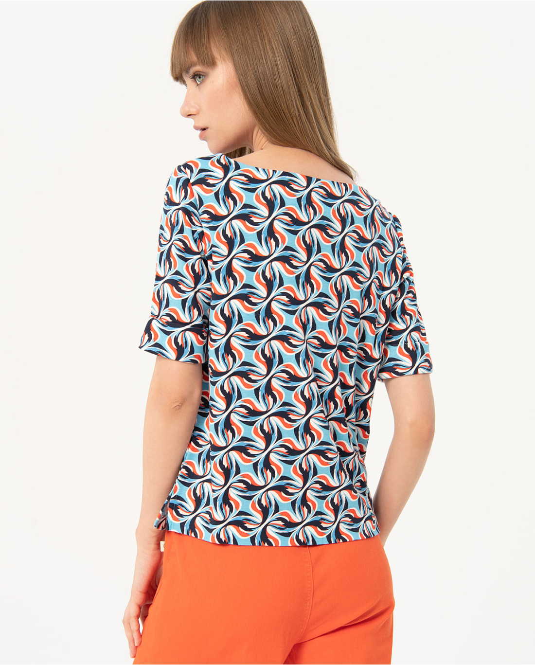 Fashion-forward patterned top with colorful retro motif and flattering relaxed fit for stylish office-to-weekend wear.