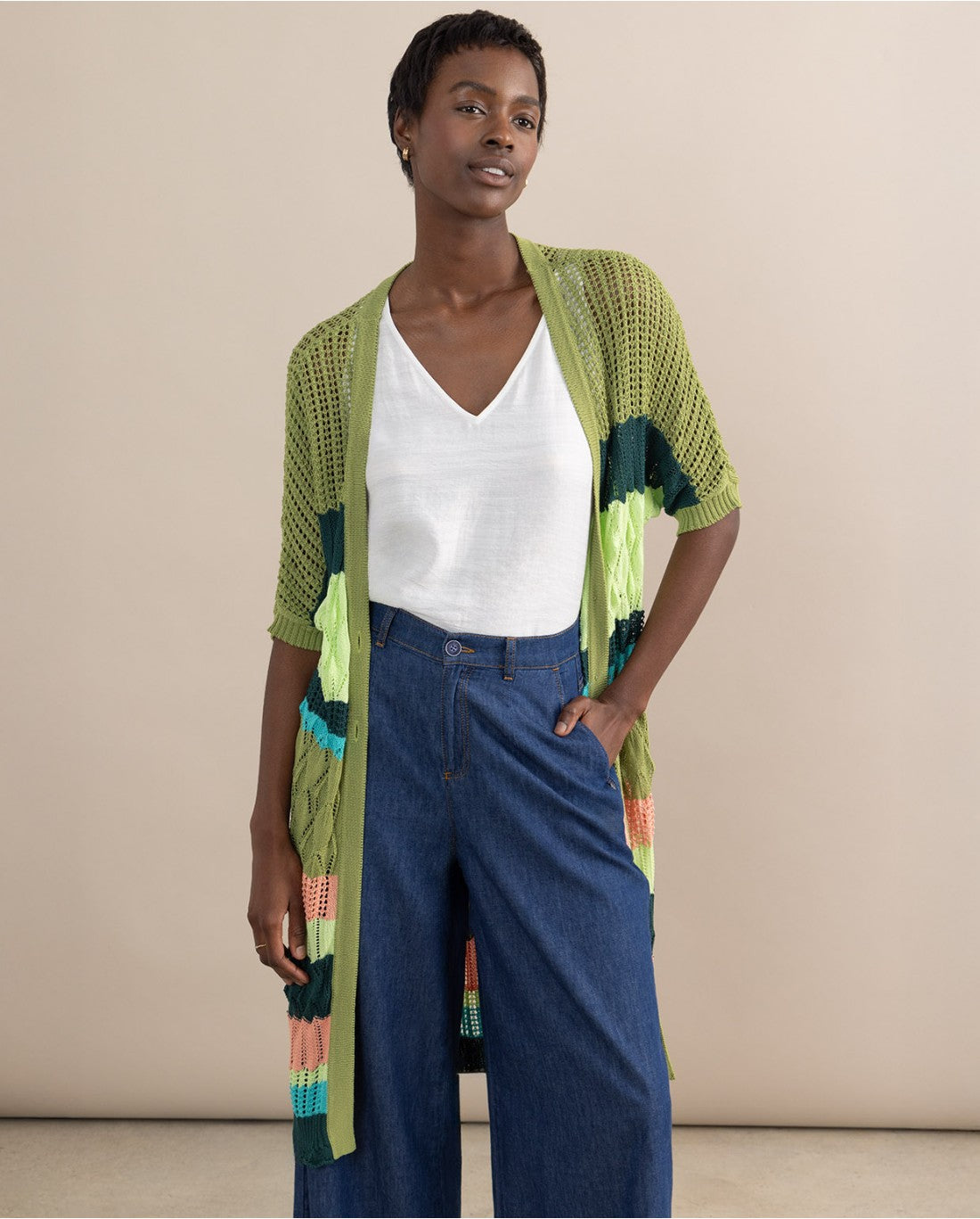 Resort-inspired longline knit cardigan with vibrant stripe accents and effortless relaxed elegance.