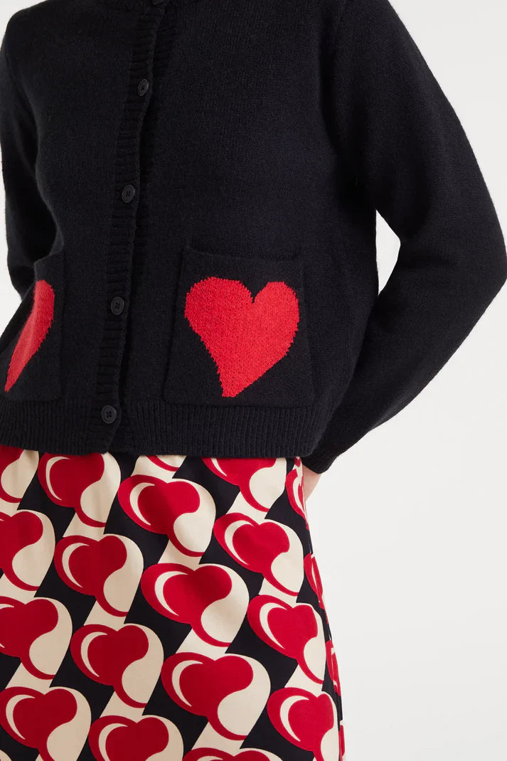 Close up of pockets on this minimalist women’s knit cardigan with standout red heart accents