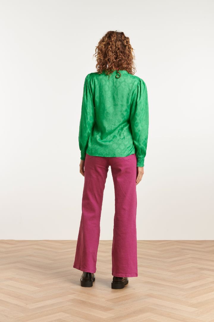 Fashion-forward emerald green long sleeve blouse with soft sheen fabric and relaxed tailored silhouette for modern styling.
