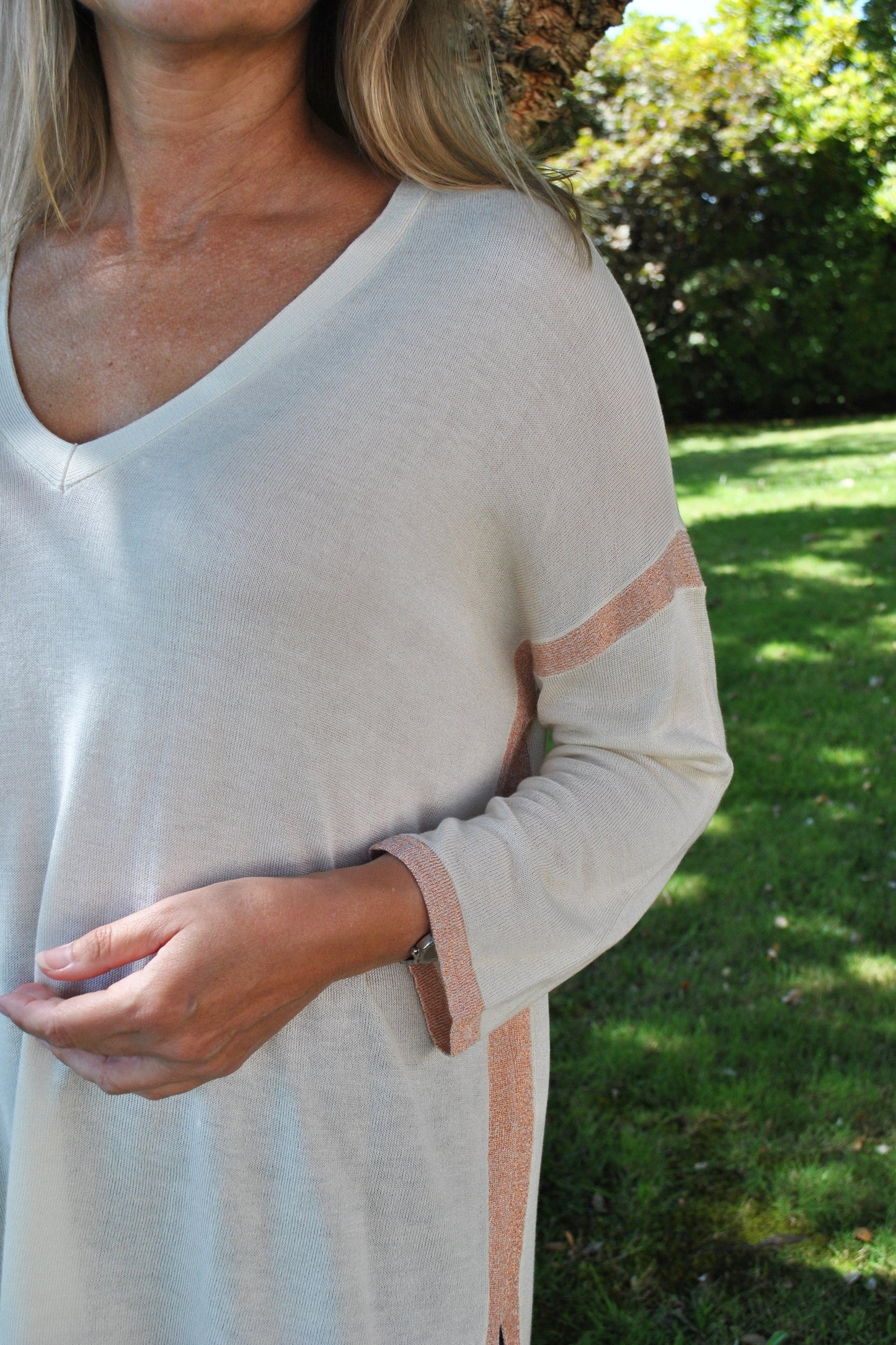 Women’s cozy oversized sweater in cream with subtle pink trim and flowy fit for effortless contemporary fashion.
