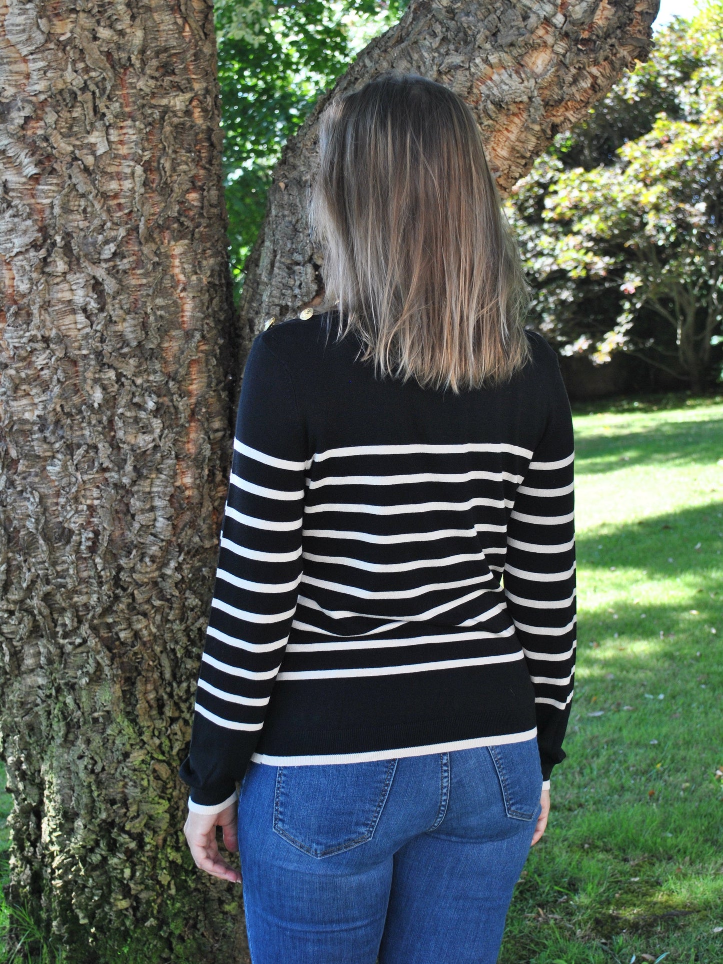 Minimalist striped knit sweater with lightweight fabric and timeless monochrome style for everyday layering fashion.