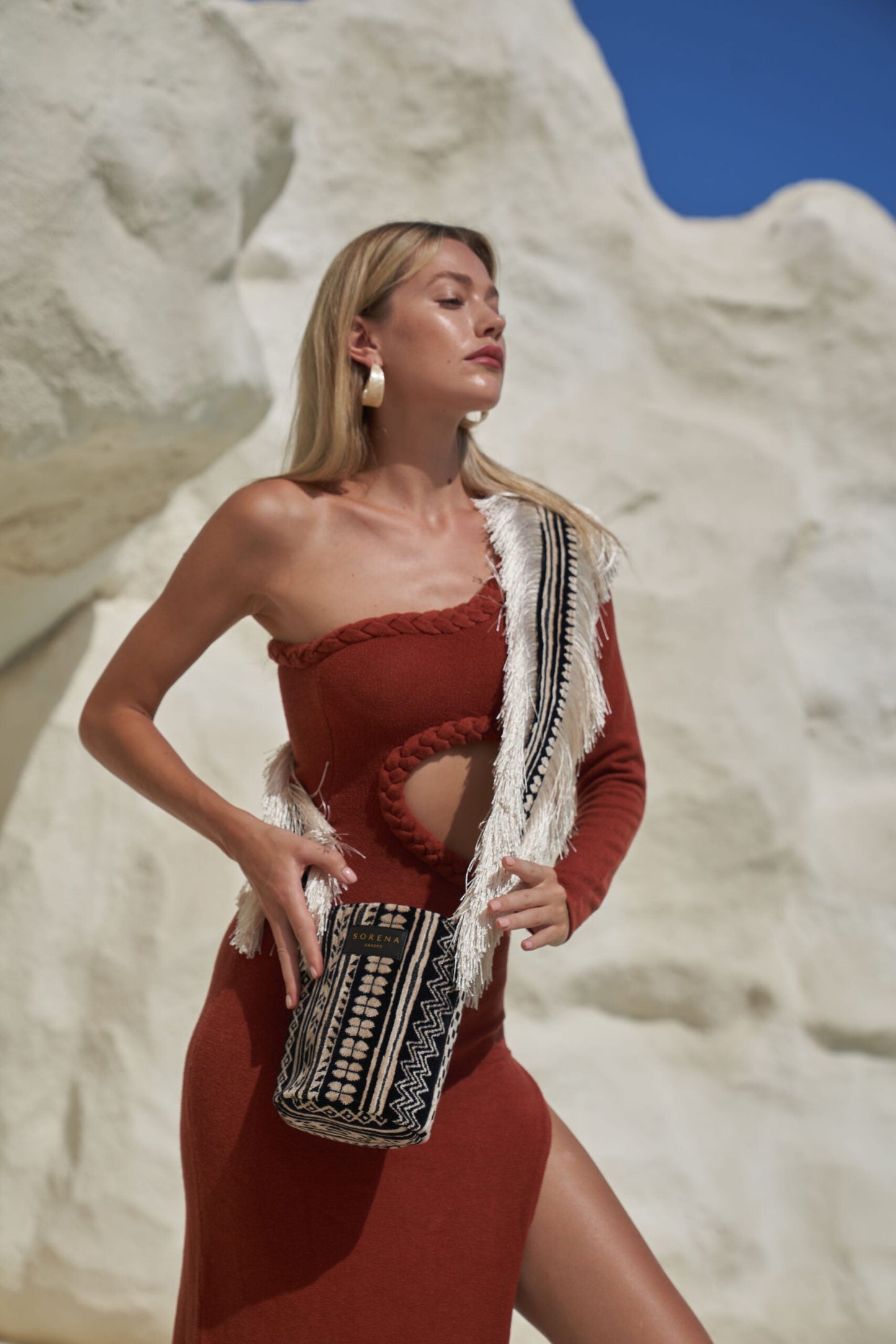 Women’s luxury bohemian crossbody bag with tribal pattern design and statement textured fringe finish.