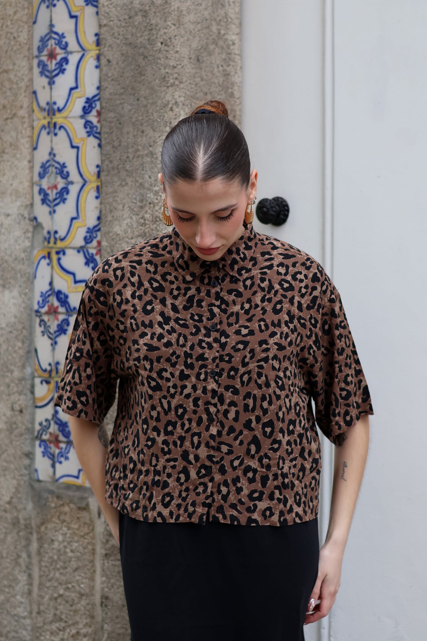 Fashion-forward oversized leopard print top with collared neckline and effortless cool-girl vibe.