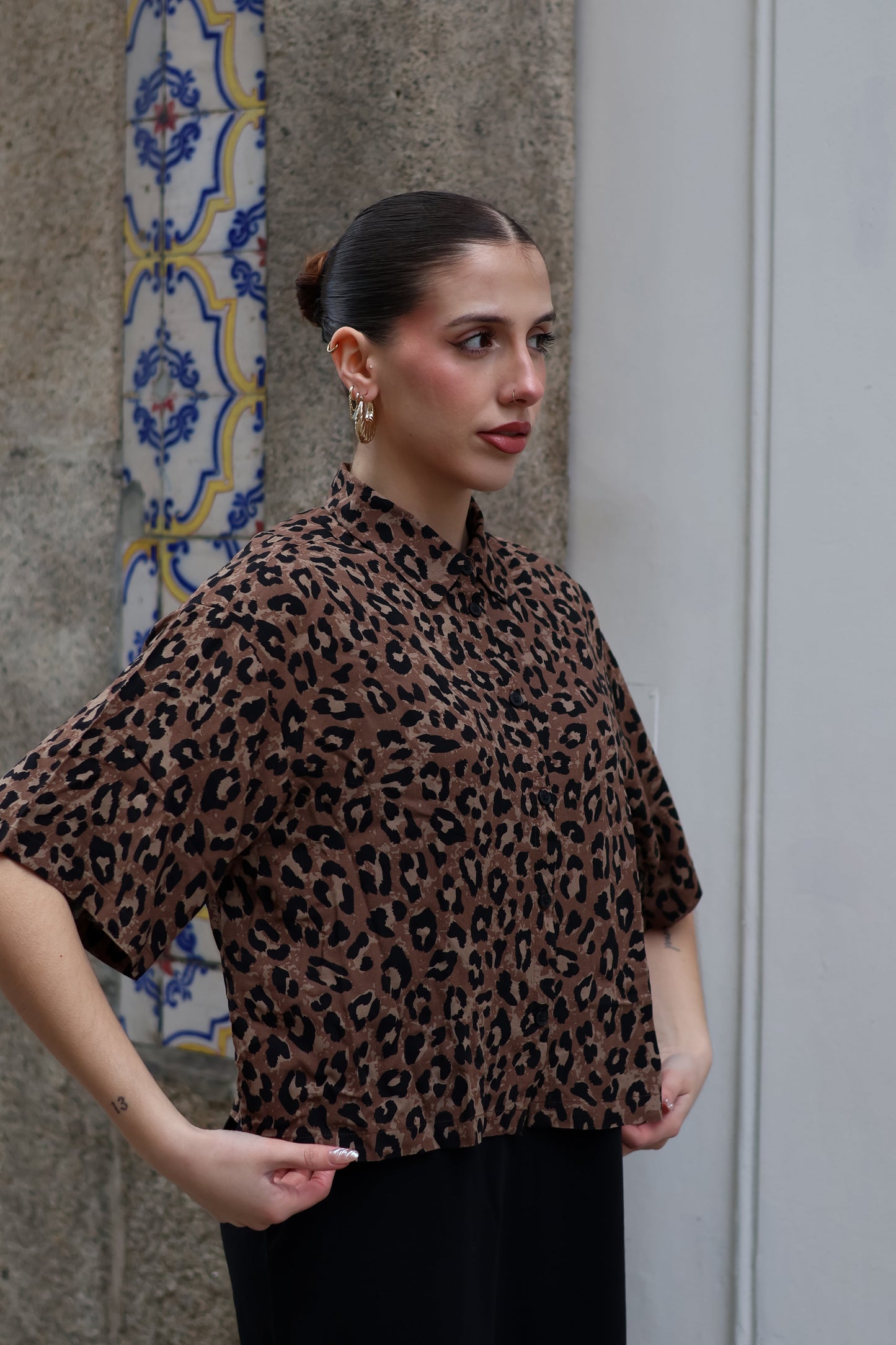 Women’s relaxed-fit leopard print button-up top with modern urban chic and statement styling.