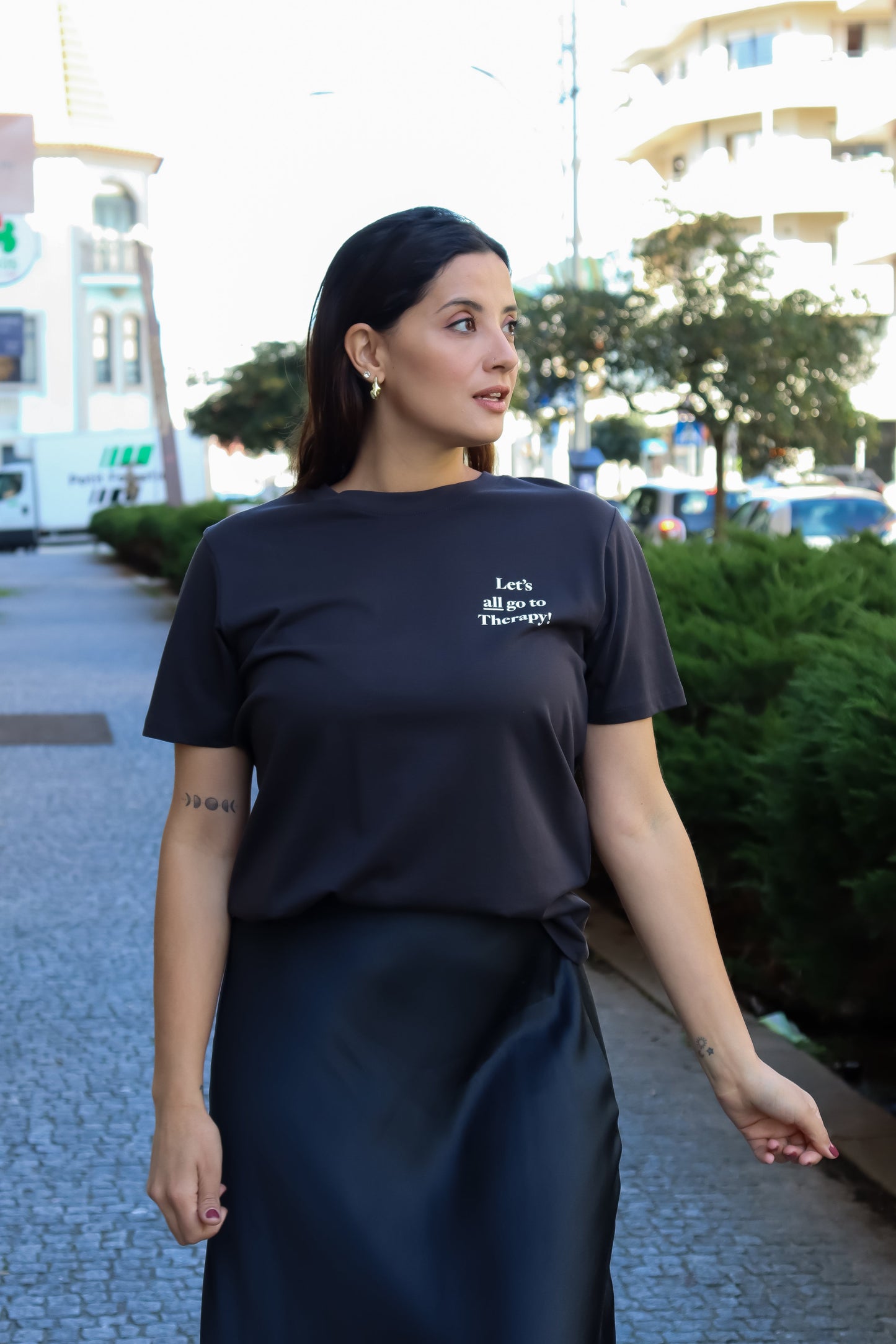 Women’s casual slogan tee in black with relaxed fit and trendy graphic typography fashion aesthetic.