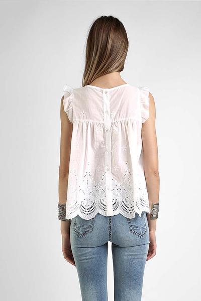 Premium embroidered white blouse with scalloped hem and boutique-quality craftsmanship.