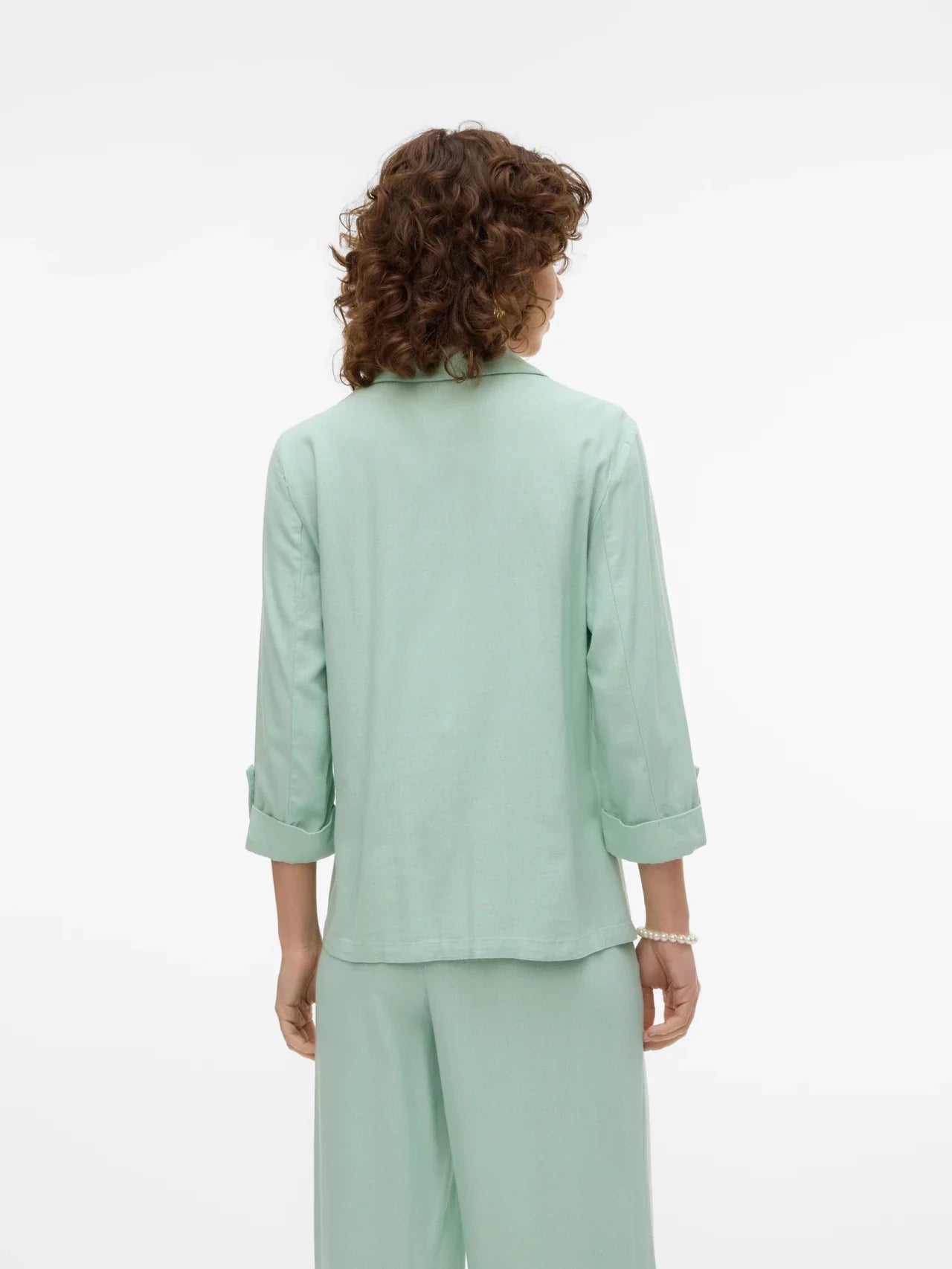 Soft mint green blazer for women featuring relaxed tailoring and sophisticated casual chic appeal.