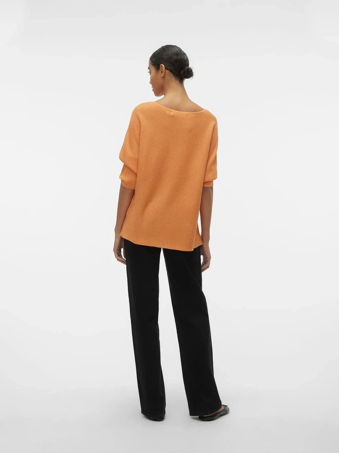 Minimalist oversized orange sweater featuring soft ribbed fabric and easy relaxed fit for all-season casual fashion.