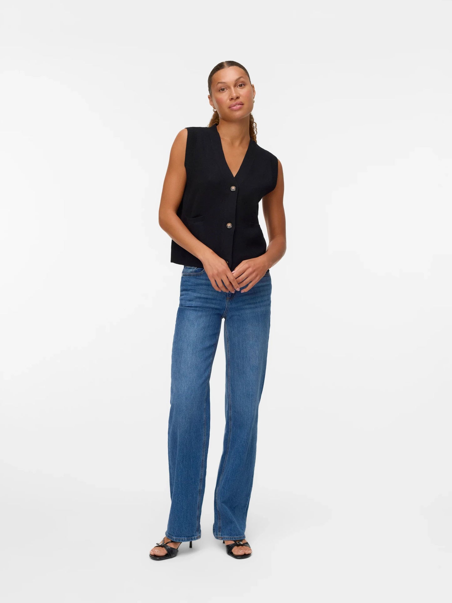 Modern women’s black knit vest with understated elegant aesthetic