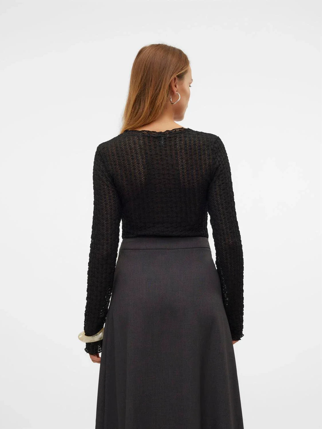 Women’s long sleeve black shimmer top with delicate sheer texture and sleek minimalist fashion appeal.