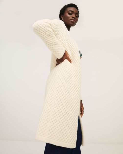Cozy cream cardigan sweater with open front design and modern casual-chic aesthetic.