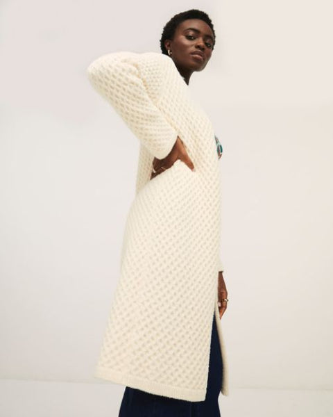 Cozy cream cardigan sweater with open front design and modern casual-chic aesthetic.