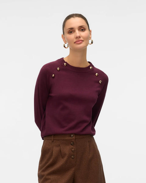 Women's burgundy crew neck knit sweater with decorative gold-tone shoulder buttons and long sleeves for elevated everyday outfits.