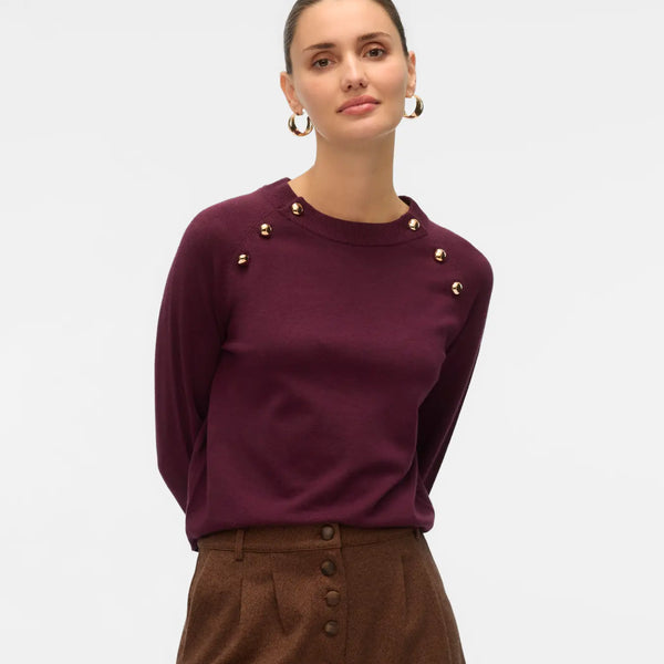 Women's burgundy crew neck knit sweater with decorative gold-tone shoulder buttons and long sleeves for elevated everyday outfits.