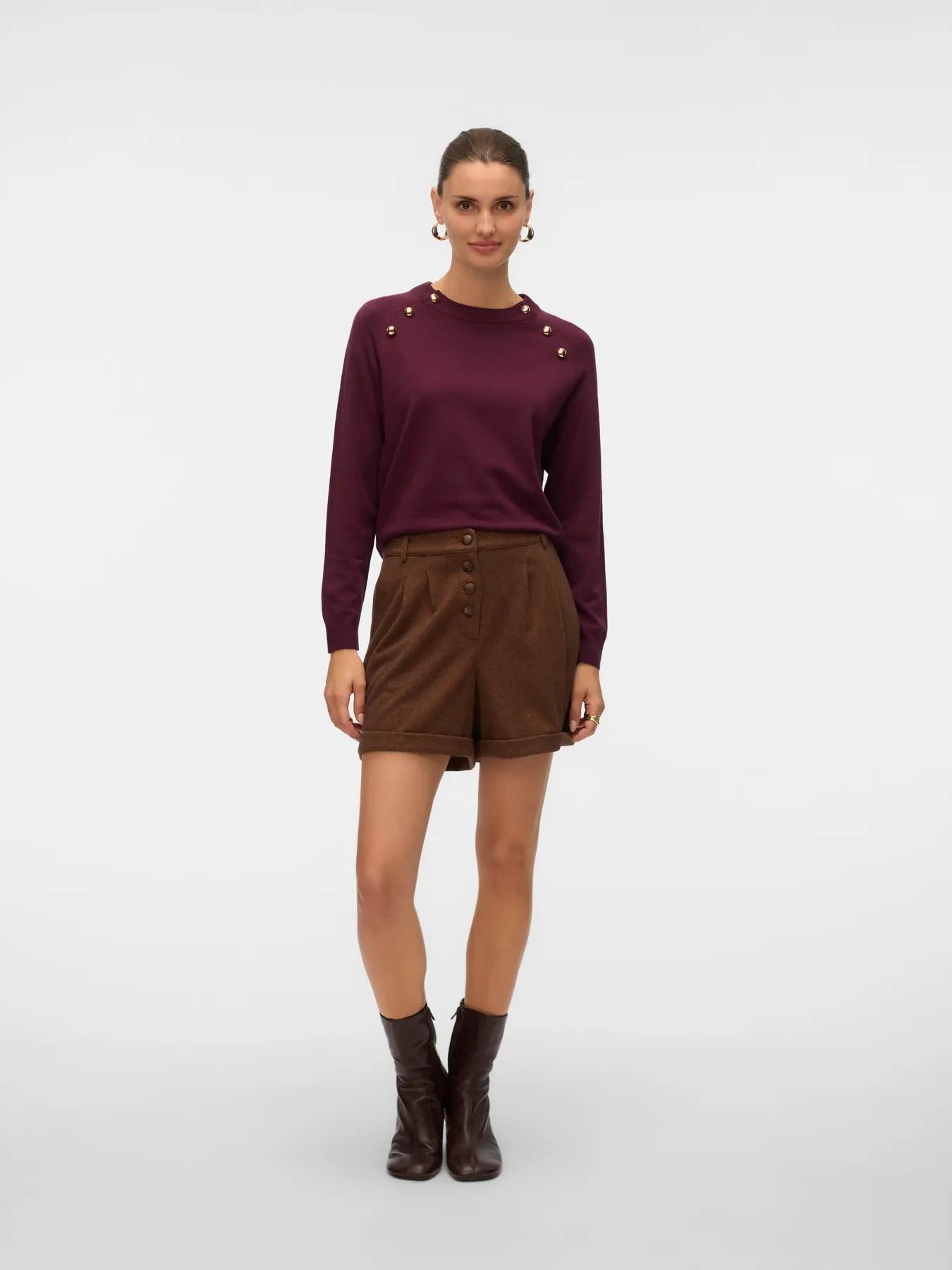 Women's deep plum crew neck sweater with decorative gold metallic buttons and long sleeves for a polished capsule wardrobe.