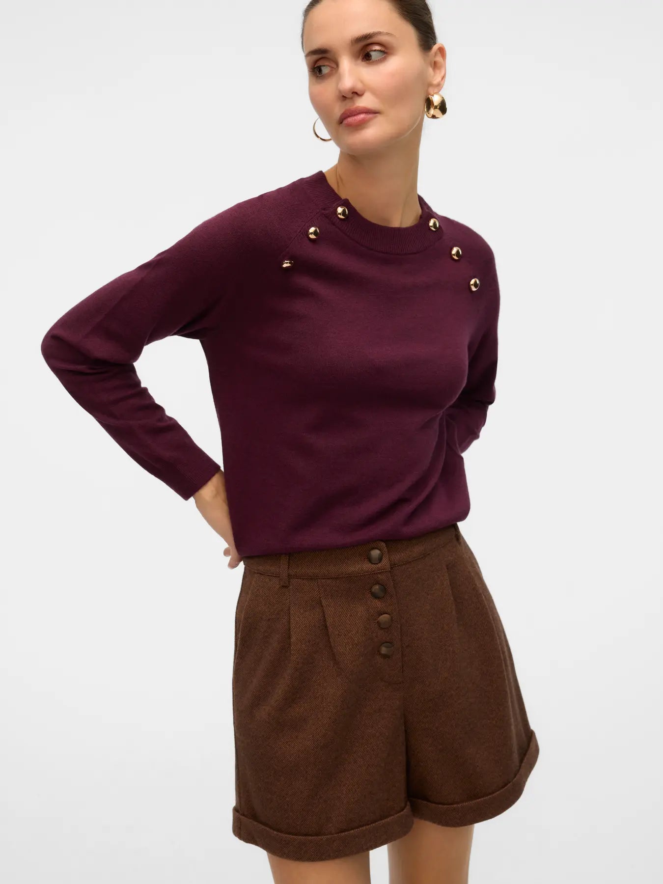 Women's elegant wine-colored long-sleeve sweater with statement gold buttons for polished smart casual styling.
