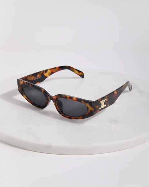 Elegant women's tortoise frame sunglasses featuring lightweight construction and modern designer-inspired styling.