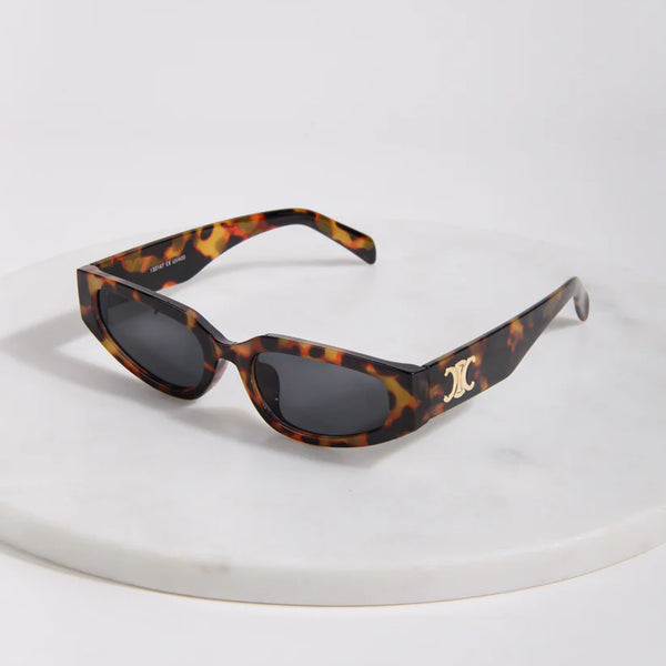 Elegant women's tortoise frame sunglasses featuring lightweight construction and modern designer-inspired styling.