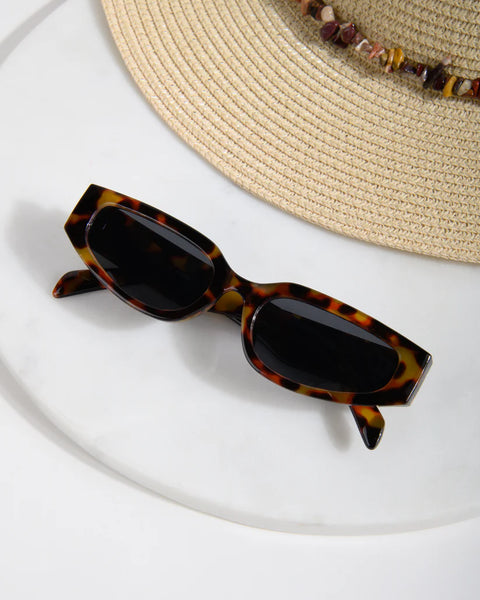 Women's vintage-inspired rectangle sunglasses with a polished tortoise finish and sleek dark lenses.
