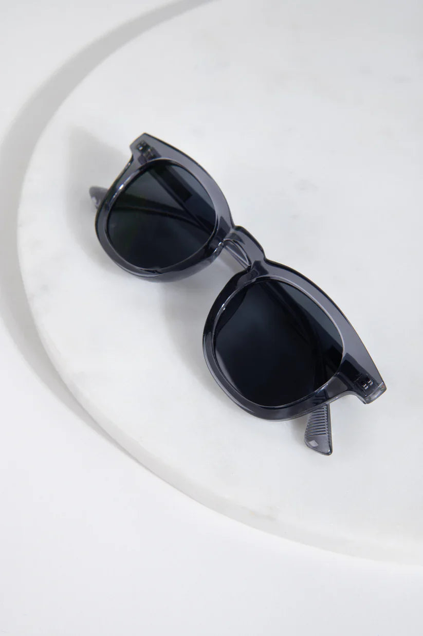 Designer-look translucent sunglasses with dark lenses and timeless modern fashion statement vibe.