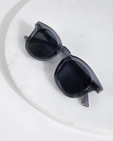 Designer-look translucent sunglasses with dark lenses and timeless modern fashion statement vibe.