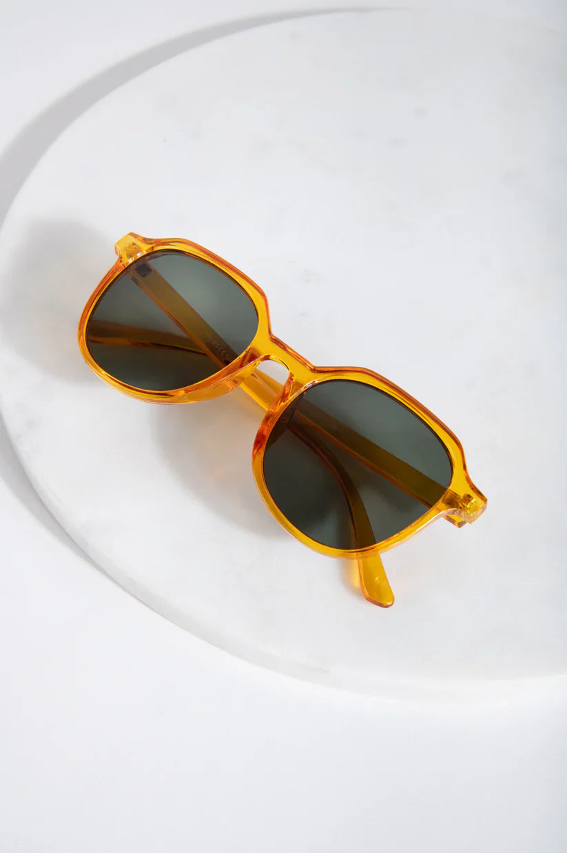 Minimalist designer-inspired sunglasses featuring lightweight translucent frames and modern cool-girl aesthetic.