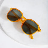 Minimalist designer-inspired sunglasses featuring lightweight translucent frames and modern cool-girl aesthetic.