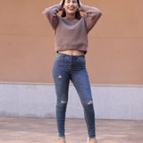 Slim-fit ripped jeans for women featuring soft blue denim, tapered ankle cut, and flattering everyday fit.