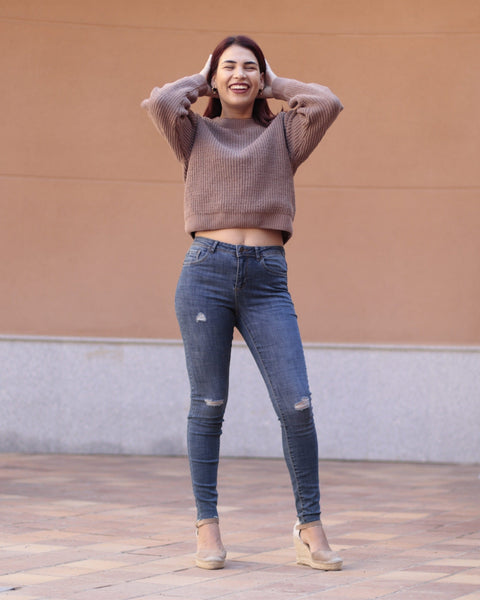 Slim-fit ripped jeans for women featuring soft blue denim, tapered ankle cut, and flattering everyday fit.