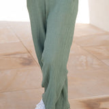 Trend-driven sage green lounge pants with relaxed tailoring and comfortable elevated basics aesthetic.