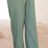 Elegant textured drawstring wide leg pants with breezy movement and effortless Mediterranean resort style.