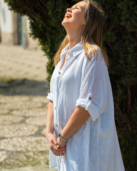 Chic oversized white beach shirt with airy texture and elevated Mediterranean vacation fashion appeal.