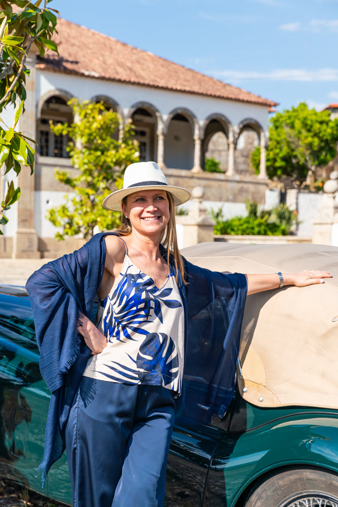 Women's resort-inspired camisole with striking blue tropical foliage print for coastal and vacation wardrobes.