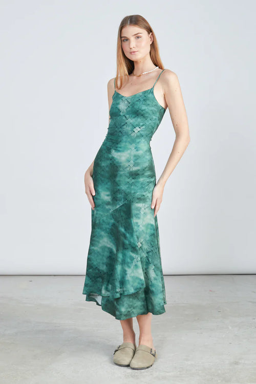 Trendy green midi slip dress featuring delicate spaghetti straps and modern resortwear fashion vibe.