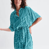 Contemporary teal belted shirt dress with loose fit and graphic print for elevated casual women’s fashion.