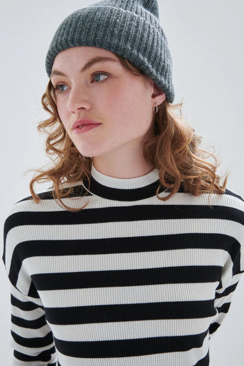 Chic black and white stripe pullover sweater with ribbed knit fabric and effortless Parisian-inspired style.