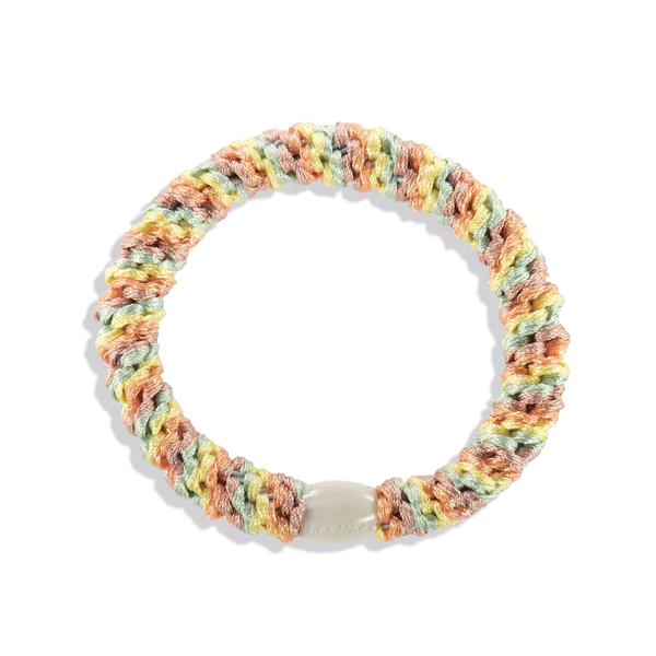 Stretch woven tutti frutti ponytail holder with soft braided fabric and secure flexible grip for thick, thin, or curly hair types.