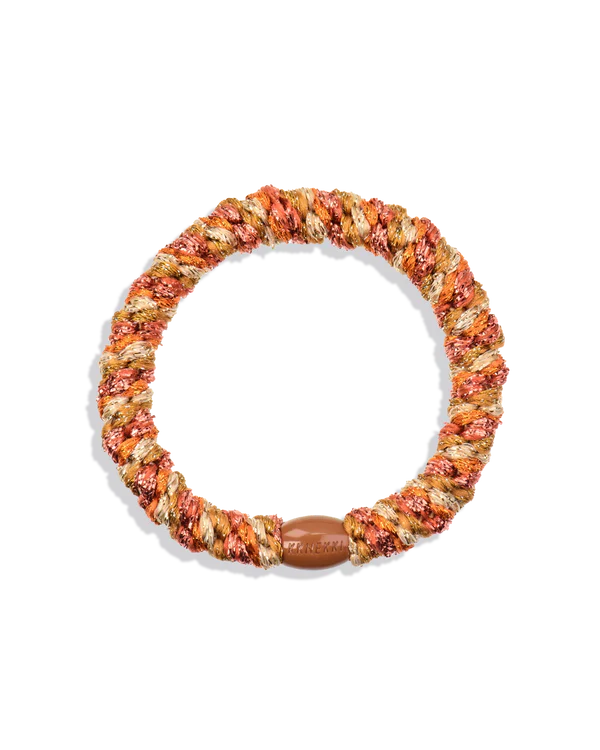 Soft braided hair tie in warm orange and neutral tones with stretch elastic design for all-day comfortable hold and no hair pulling.